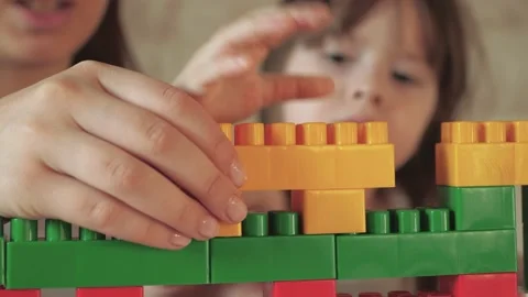 Little child plays constructor with his mother. happy family. kid builds multi Video stock 202192576