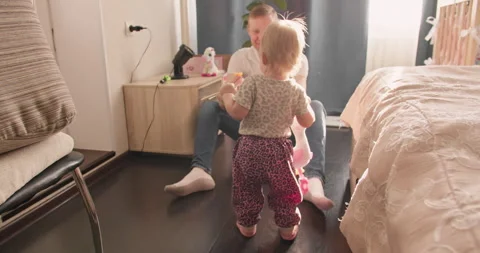 Little child practicing first steps in apartment Stock Footage 336814673