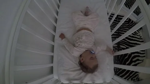 Little child is sleeping in the crib timelapse Stock Footage