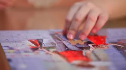Little child solving a puzzle Video stock 10803929