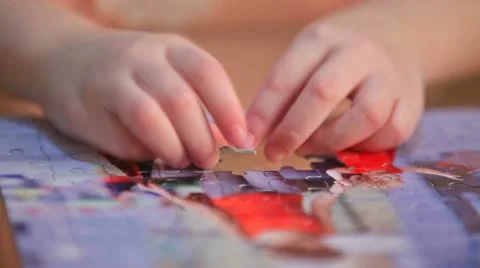 Little child solving a puzzle Stock Footage 10806967