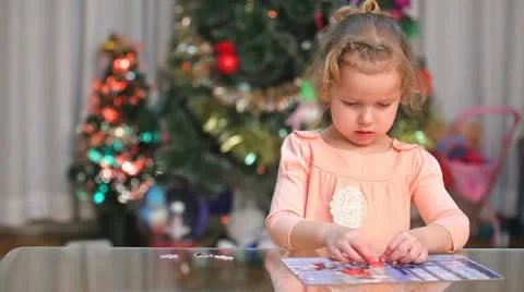 Little child solving a puzzle Stock Footage 10807574