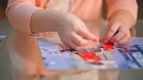 Little child solving a puzzle Stock Footage 10855354