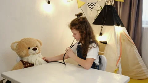 Little child using stethoscope, playing as nurse or veterinarian with fluffy toy Видео 166019558
