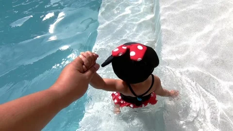 Little child walking on the edge of the pool Stock Footage 133067445