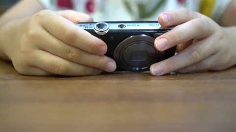 A little child who is using a digital camera to view photos. Video stock 111509955