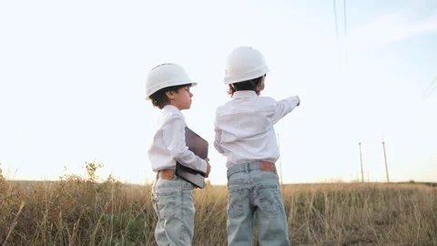 Little children as engineers or managers, safety helmets, talking work on site Stock Footage 289853004