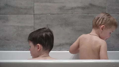 Little children playing in the bath during the bathing. Stock Footage 330738155