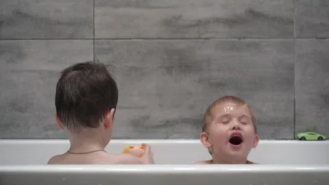 Little children playing in the bath during the bathing. Stock Footage 330738331