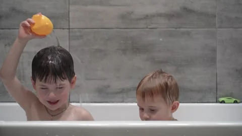 Little children playing in the bath during the bathing. Stock Footage 330738544