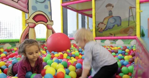 Little children playing in the pool with plastic balls in the nursery. Stock Footage 86086332