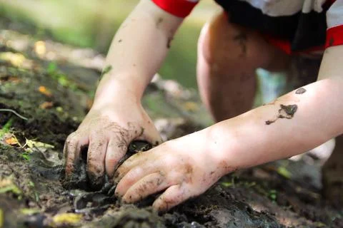 Little Child's Hands Digging in the Mud Stock Photos