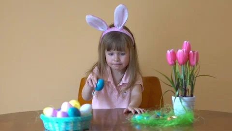 Little cute baby is playing with Easter colorful eggs Stock Footage 105087334