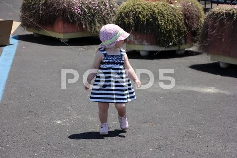 Little cute blond girl at the port in porto cervo. sardinia Stock Photos