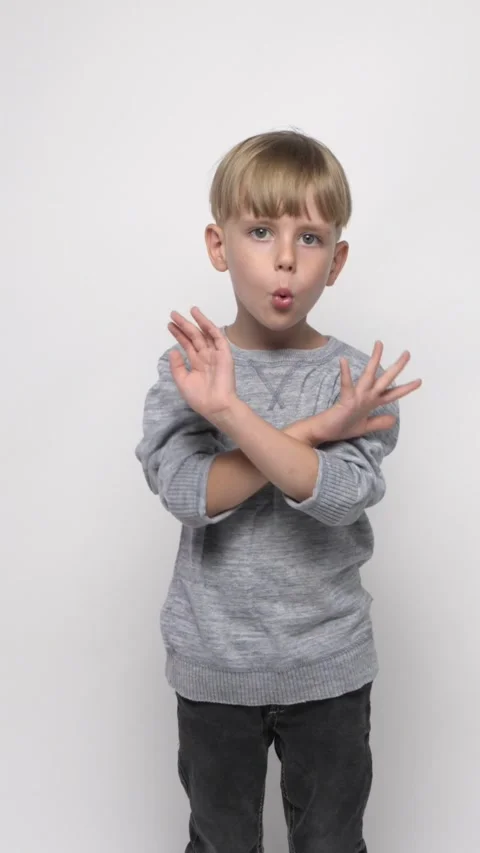 Little cute boy crossing hands like a forbidding gesture Video stock 282307053