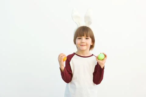 Little cute boy with Easter eggs in his hands and bunny ears on his head Fotos de archivo