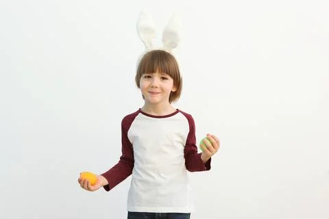 Little cute boy with Easter eggs in his hands and bunny ears on his head Fotos de archivo