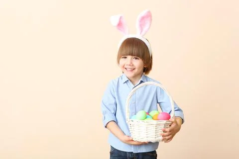 Little cute boy with Easter eggs in his hands and bunny ears on his head Stock-Fotos