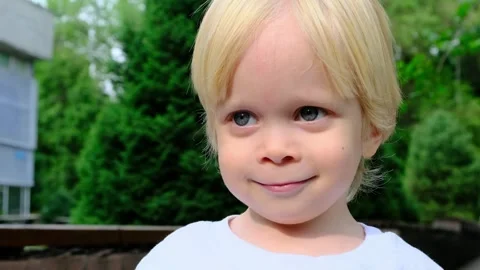 Little cute boy looking at the camera and smiling. Stock Footage 270395195