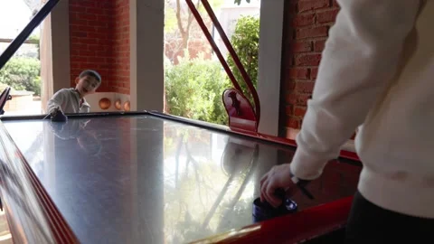 Little cute boy plays a table hockey with father Stock Footage 244828871