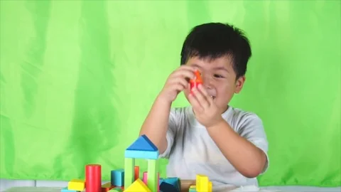 Little Cute boy put the colored bricks together, play indoor 스톡 동영상 77292770