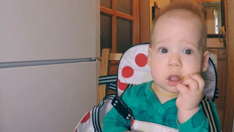 A little cute boy with two lower teeth eats straw and smiles broadly while Stock Footage 104109938