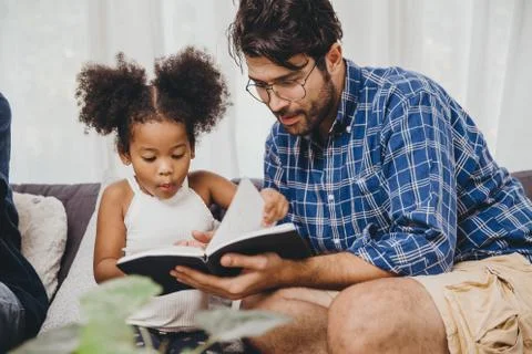 Little cute child looking amaze love to reading book and learn support from d Fotos Stock