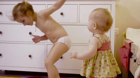 Little cute girls playing in his room. Two little girls is dancing Stock Footage