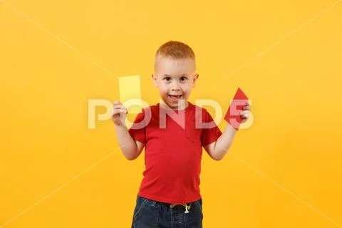 Little cute kid baby boy in red t-shirt holding in hand yellow and red soccer Stock Photos