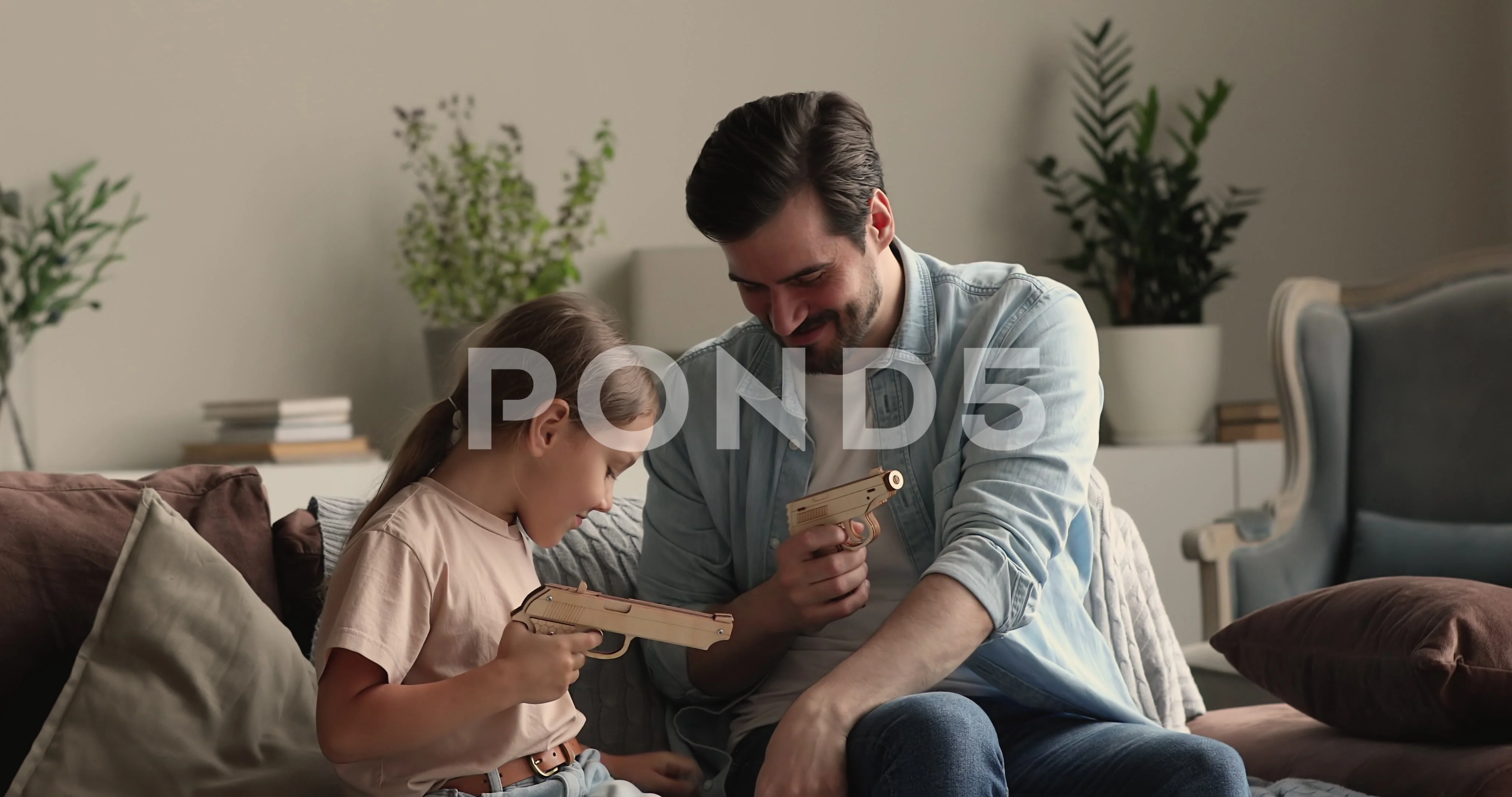 Little Daughter And Dad Shooting A Toy G Stock Video Pond5