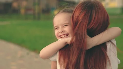 Little daughter, baby hugging mom on str... | Stock Video | Pond5