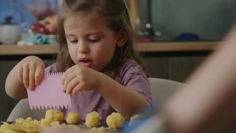 Little daughter engaging in baking session in cozy modern kitchen indoors Video stock 264634322