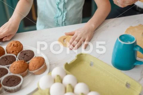 Little daughter making smile cookies in kitchen Stock Photos