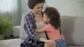 Little daughter tightly snuggling to beloved mother, full trust and affection 4k or 4k+ Resolution