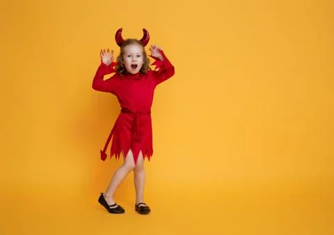 Little devil on yellow background Stock Photos
