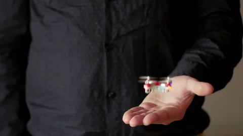 Little drone hovering above hand, flying from hand Stock Footage 84659732