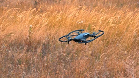 Little drone quadcopter with camera hovering in the air Stock Footage 95555587