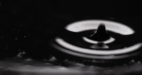 Little drop causing ripples in an unknown filthy liquid Stock Footage 104428223