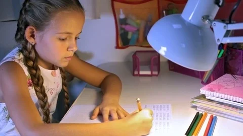 Little elementary school student doing homework Stock Footage 71885791