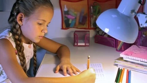 Little elementary school student doing homework Stock Footage 75417672