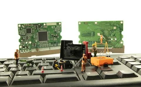 Little figures try to hack the computer system Stock Photos