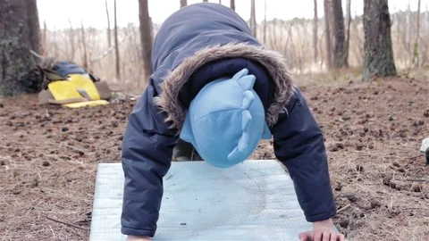 Little funny boy doing push up at the forest Stock Footage 76562988