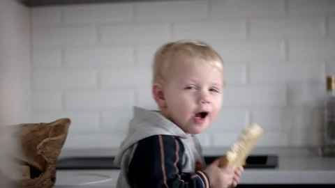 Little Funny Boy Eating Bread With Happy Face Stockbeeldmateriaal 71793312