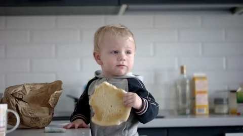 Little Funny Boy Eating Bread With Happy Face Stock Footage 71793396