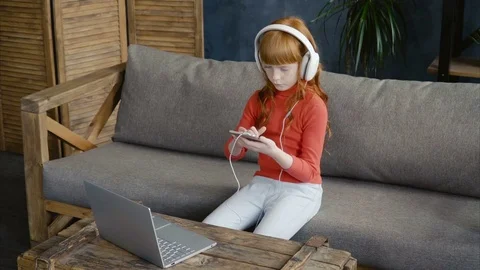 Little gir using smartphone on sofa Stock Footage 76261406
