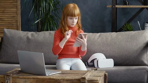 Little gir using smartphone on sofa  Stock Footage 76261845