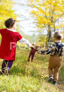 Little girl and boy walking with their favorite toy Stock Photos