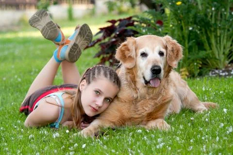 Little girl and a dog in an outdoor setting Stock Photos