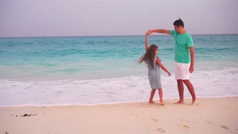 Little girl and happy dad having fun during beach vacation Stock Footage