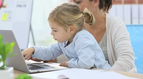 Little girl and working mom sing laptop computer Stock Footage